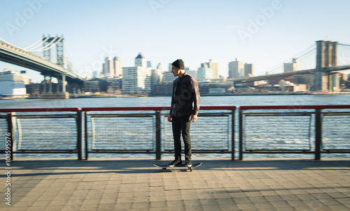 Young skateboarder cruise down on pedestrian walk