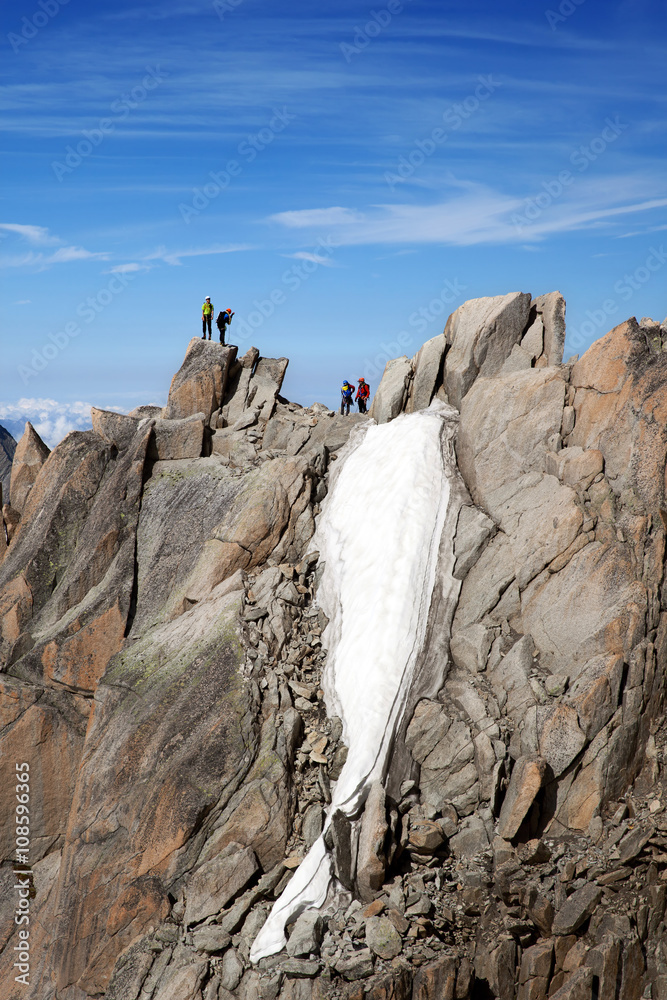 Fototapeta premium The alpinists on top of cliff in French Alps