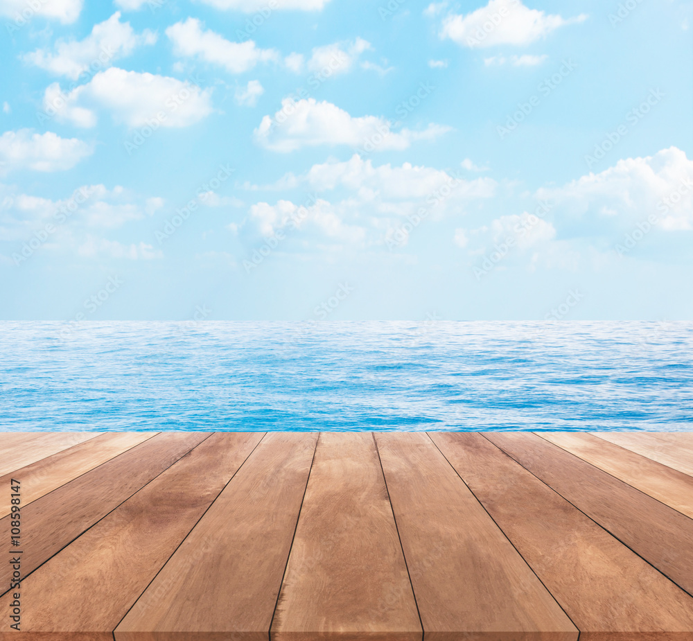 Wood table top on blue sea and sky background
