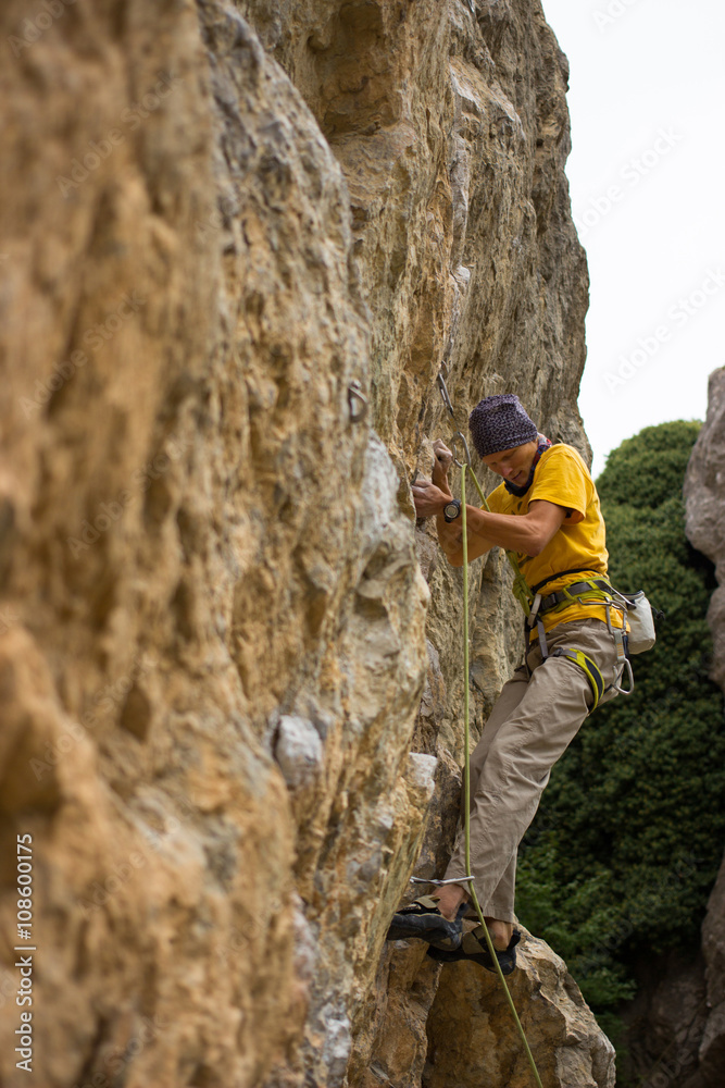 Young male climber hanging on a cliff with a rope. Young male climber hanging on a cliff with a rope.
