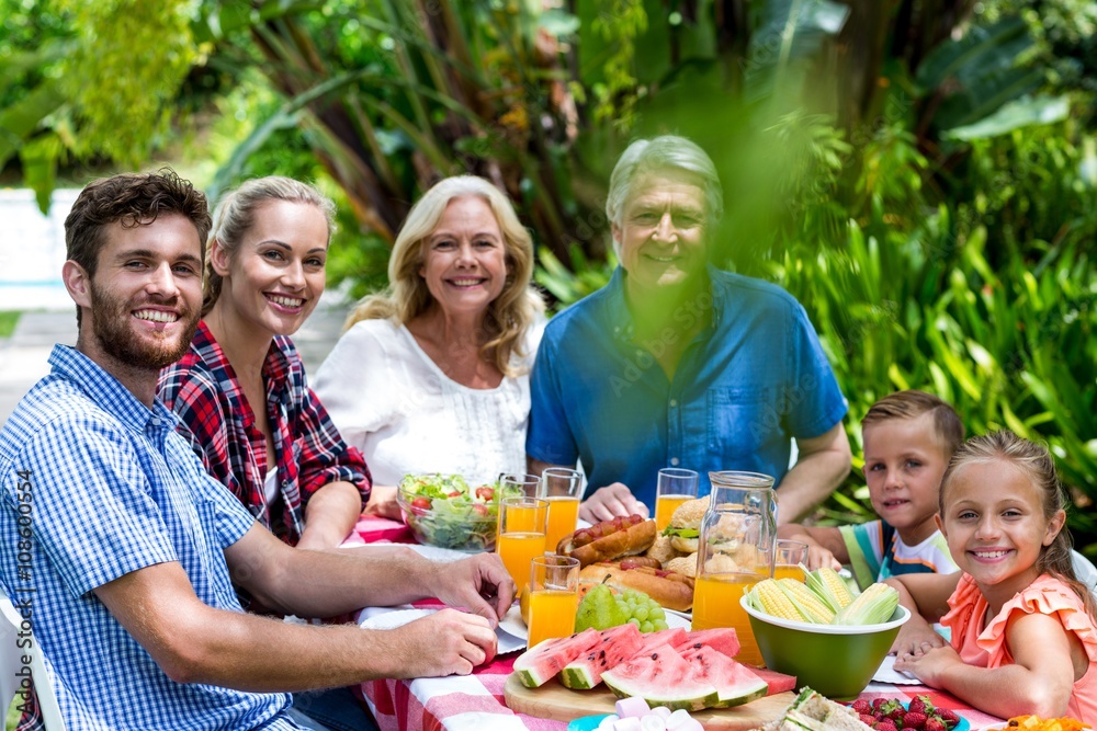 Happy family having lunch in yard 