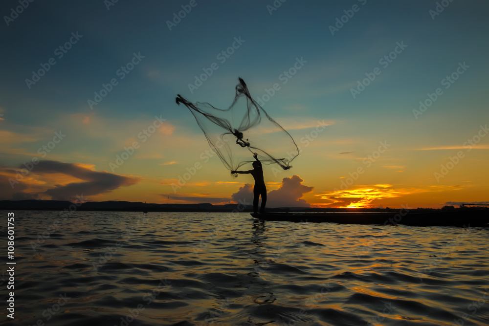  Fisherman through the net in the river.Thailand.