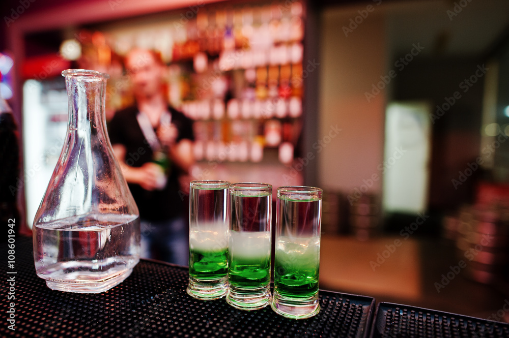 Three green mexican coctail drink and carafe background barman a