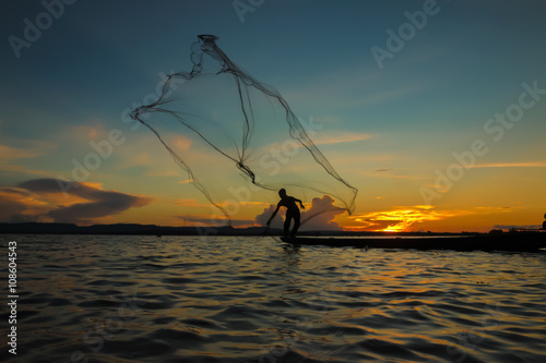 Fisherman through the net in the river.Thailand.