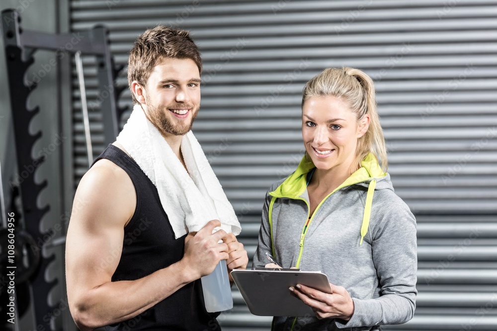 Fototapeta premium Smiling fit couple taking notes 