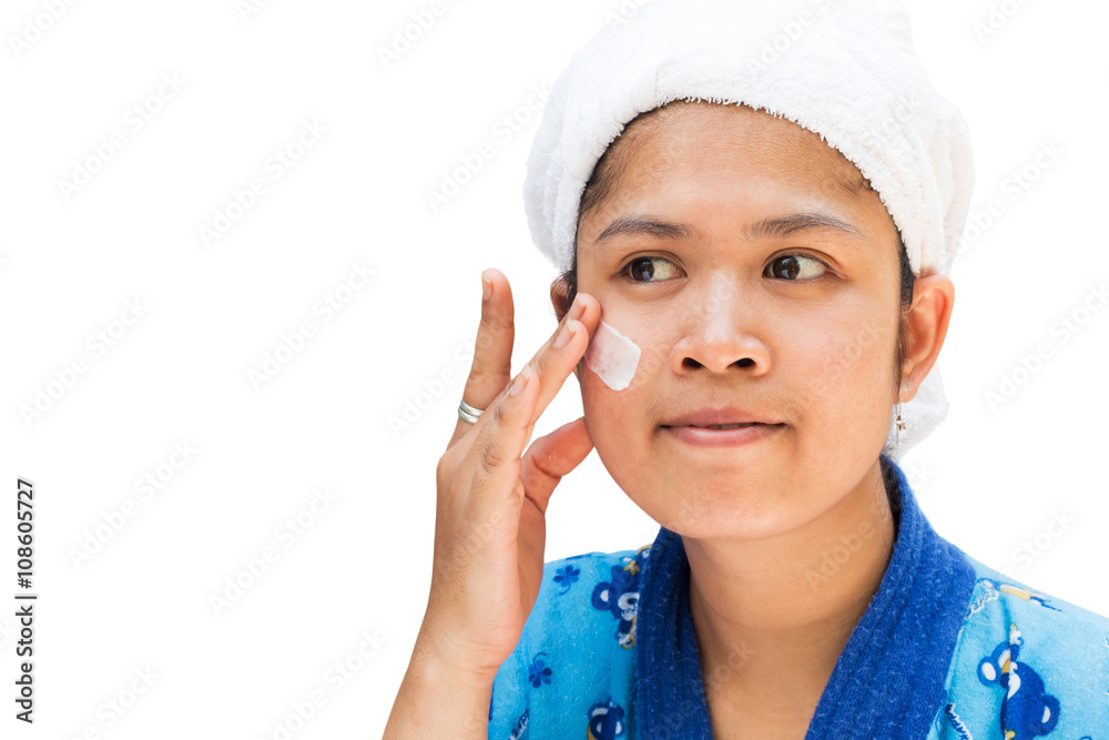 Woman applying moisturizer cream on her pretty face Woman applying moisturizer cream on her pretty face