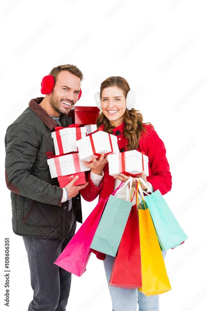 Happy young couple holding gifts and shopping bags Happy young couple holding gifts and shopping bags