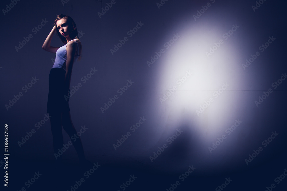 High fashion model posing in hat posing in light background