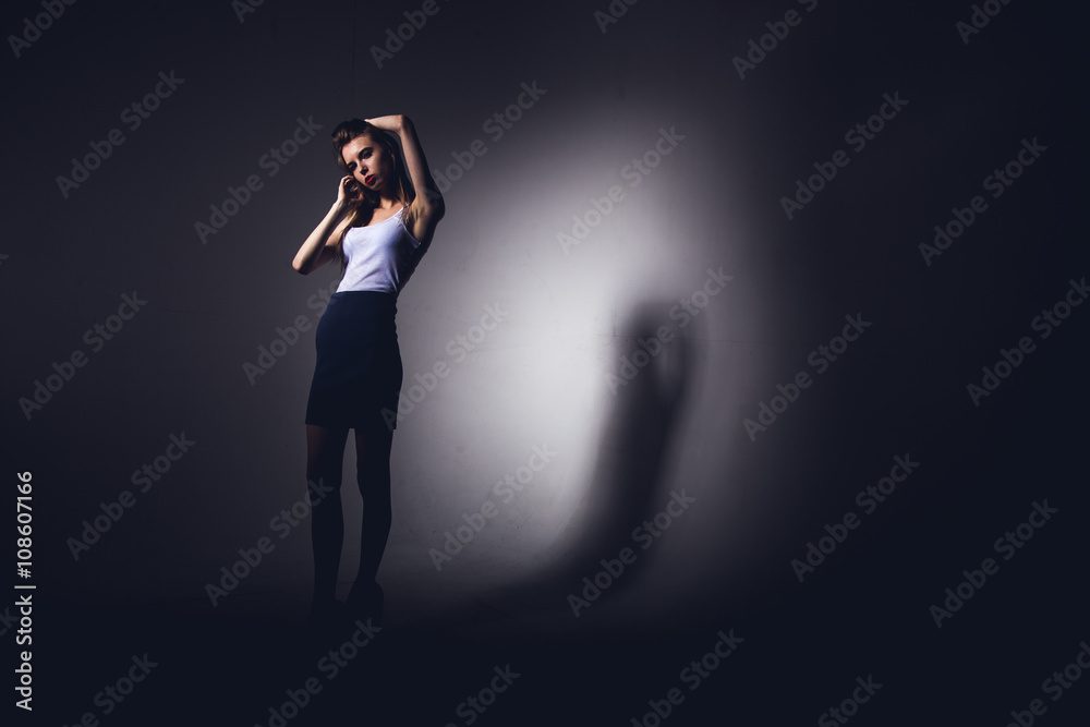 High fashion model posing in hat posing in light background