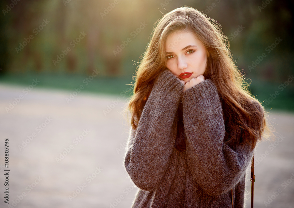 young beautiful girl with long hair brown hair, expressive cheekbones free  warm sweater and pants with a film camera in hand walks on spring park  Stock Photo | Adobe Stock