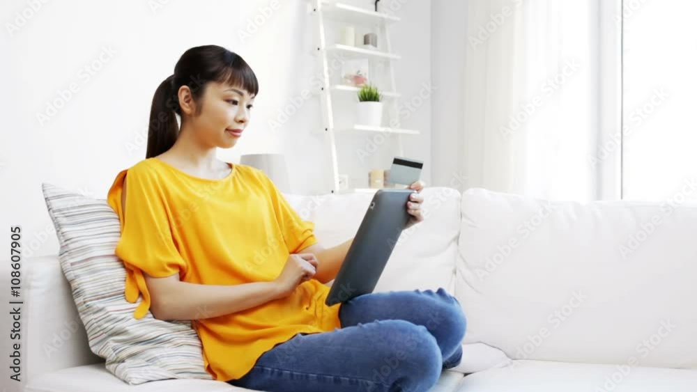 happy asian woman with tablet pc and credit card happy asian woman with tablet pc and credit card