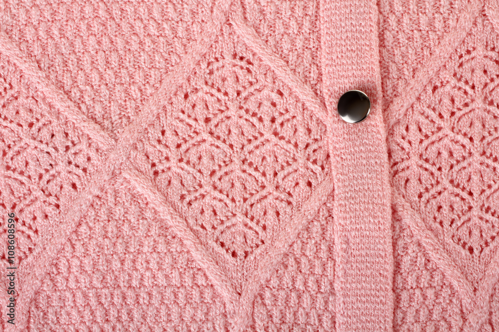 the texture of the peach hue of clothing with buttons closeup the texture of the peach hue of clothing with buttons closeup