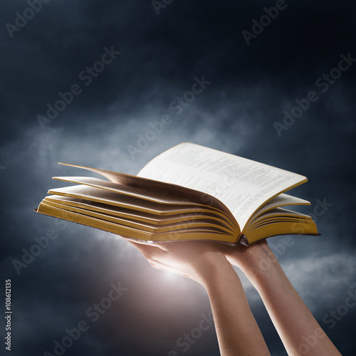 Opened book on a dark sky background