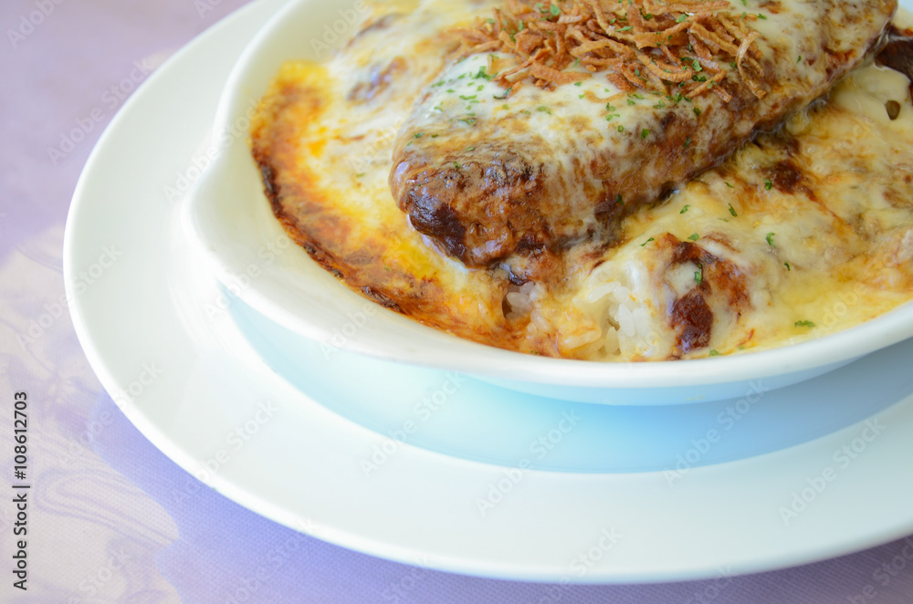 Omelette rice with grilled pork on white plate Omelette rice with grilled pork on white plate