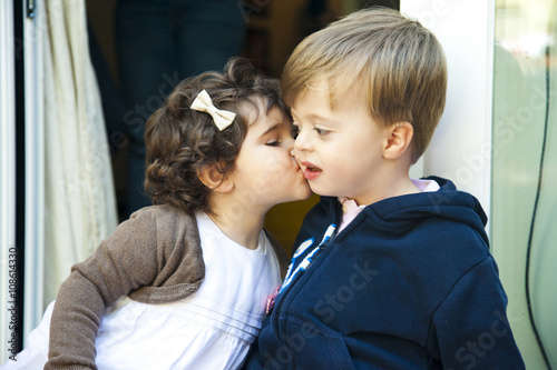 Medium shot girl kissing a boy