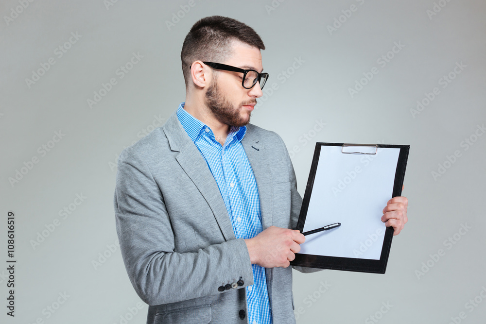 Businessman showing blank clipboard Businessman showing blank clipboard