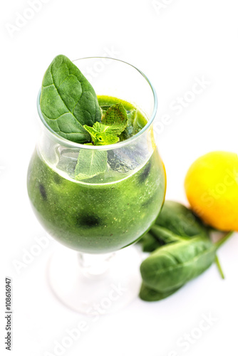 fresh green smoothie with spinach leaf and lemon in glass isolated on white background, spinach, cucumber, apple fruit drink, product photography for healthy lifestyle