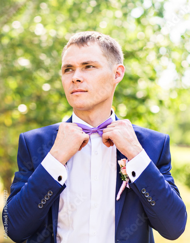 Sexy man in tuxedo and bow tie posing