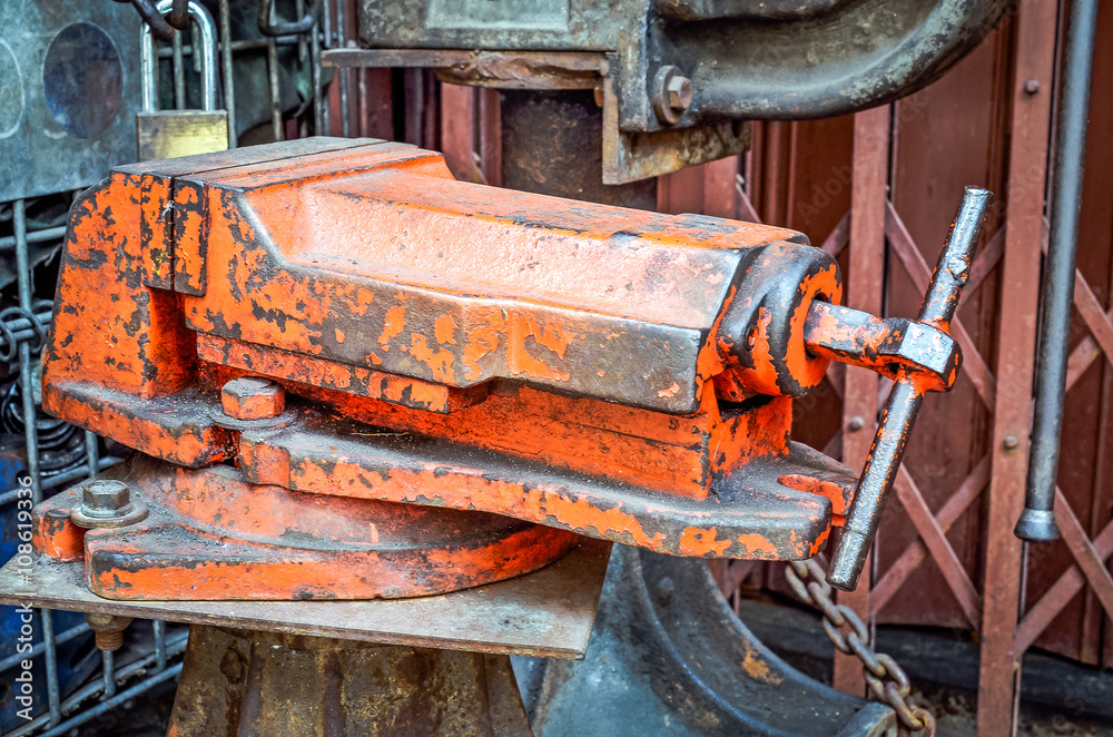 Red old vice for engineering tools, the worker of paths is present Red old vice for engineering tools, the worker of paths is present