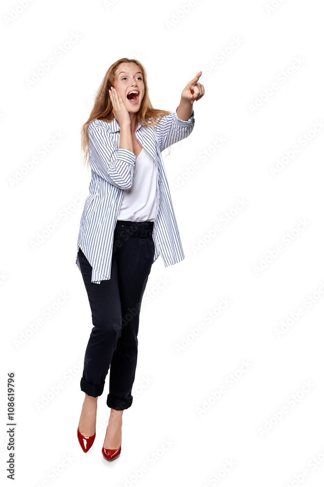 Happy excited woman in full length pointing to the side Happy excited woman in full length pointing to the side