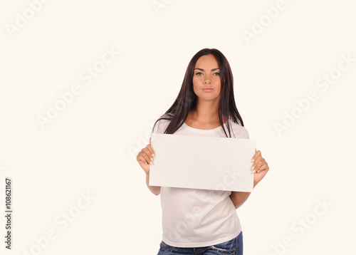 Beautiful girl holding a blank billboard