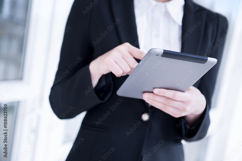 Businesswoman playing tablet- tablet Focused Businesswoman playing tablet- tablet Focused