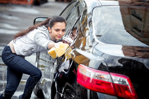 girl washes the car © producer