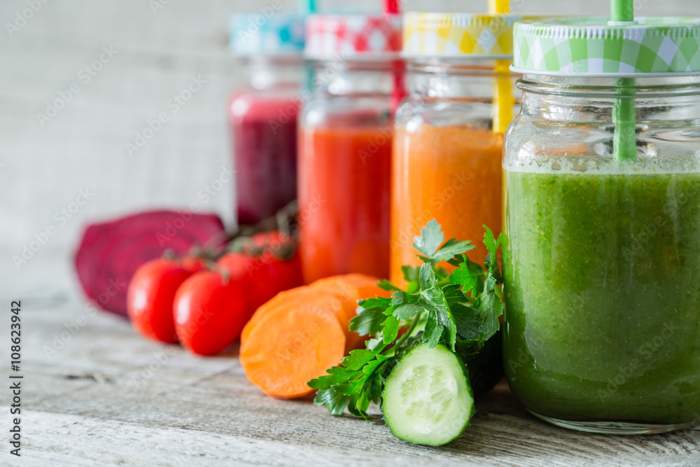 Selection of colorful vegetable juices in glass jars Selection of colorful vegetable juices in glass jars