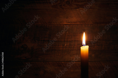 candle on old wooden background