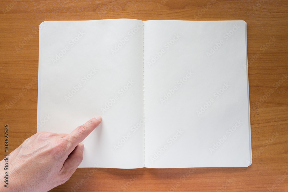 Hands pointing at notebook Hands pointing at notebook