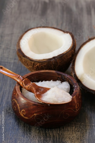 Coconut oil in a woodeen bowl, selective focus photo