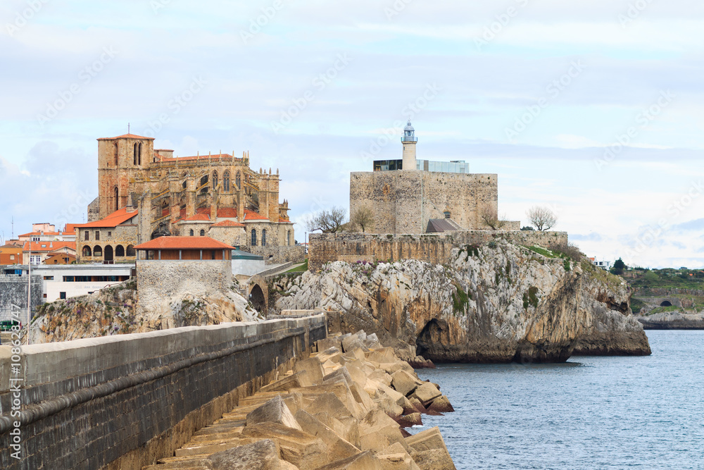 Breakwater of Castro Urdiales, with the church of Santa Maria de la Asuncion and Castle Lighthouse in the background