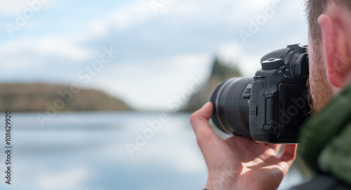 A photographer taking a pciture of a lake