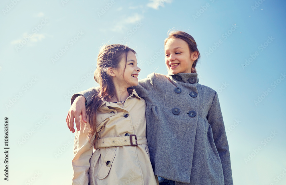 happy little girls hugging and talking outdoors happy little girls hugging and talking outdoors