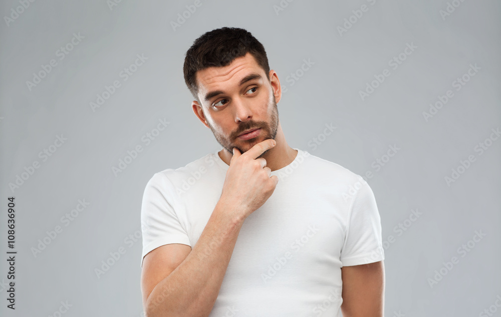 man thinking over gray background man thinking over gray background