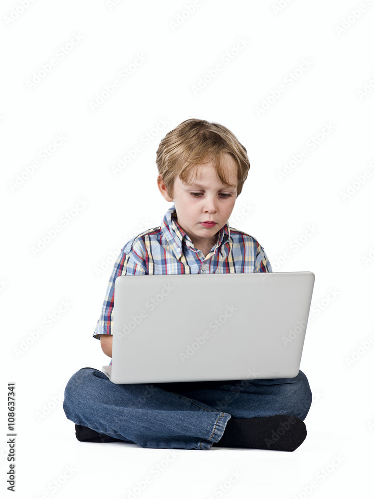front view of a elementary boy using laptop. front view of a elementary boy using laptop.