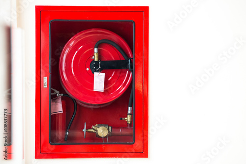 Fire safety equipment in the red box on wall cement