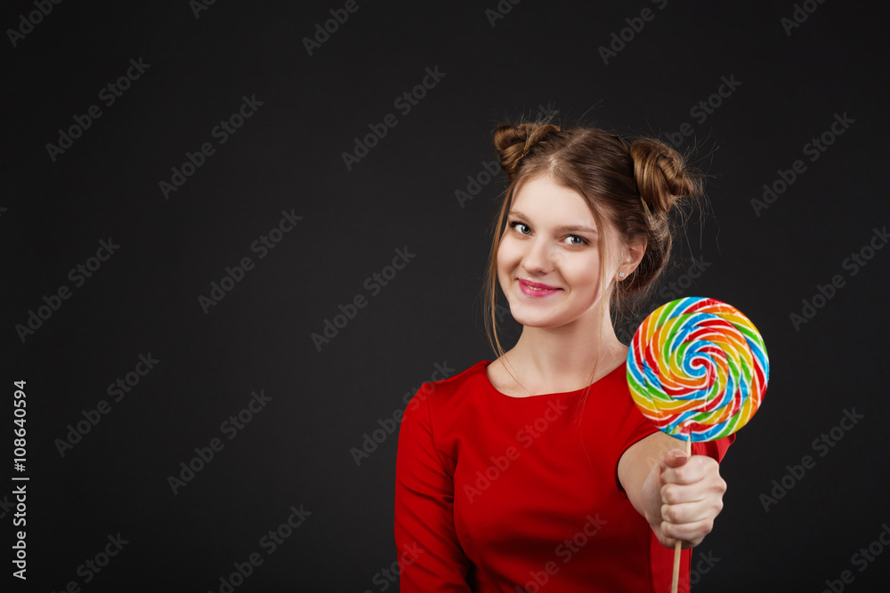 Fototapeta premium Portrait of a smiling young beautiful girl in a red dress with a