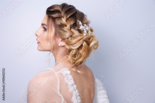 beautiful woman  bride with tiara on head  on bright background , copy space.