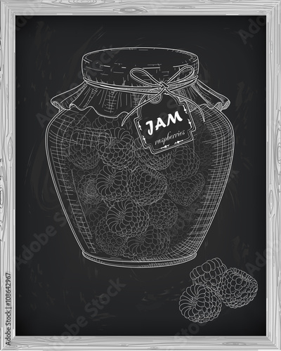 beautiful jar of homemade jam with raspberry on a black backgrou