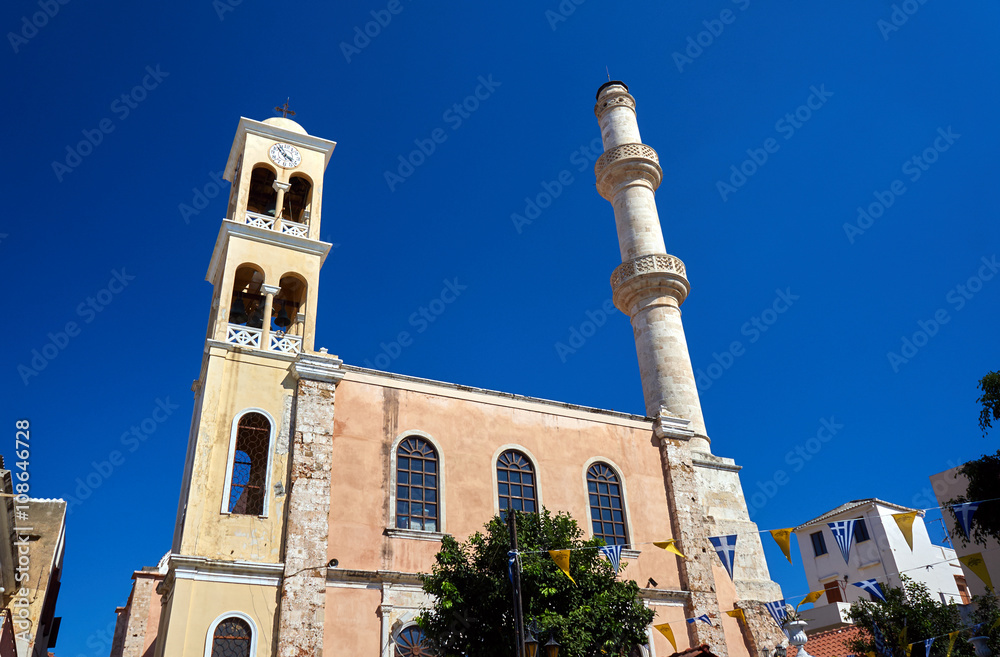 Orthodox church with a bell tower and minaret in the town of Chania, Crete.
