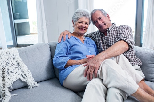 Portrait of senior couple embracing each other on sofa