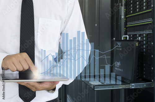 Business man use tablet for analyze in data center