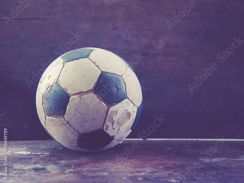 Old Soccer football on old vintage wood table morning light