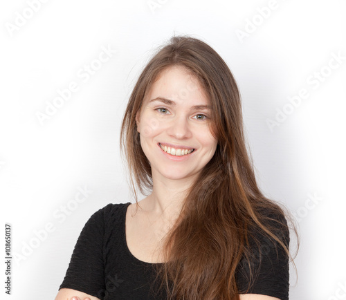 Brown-haired young woman smiles photo