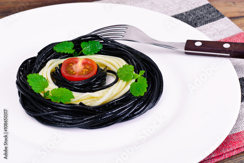 Black Spaghetti with Cuttlefish Ink, Tomato and Basil. Mediterra photo