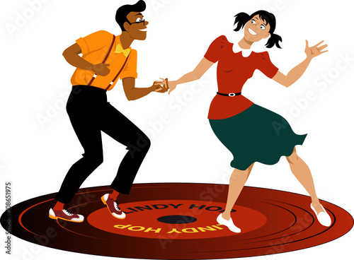 Young couple dressed in vintage attire dancing lindy hop on a vinyl record