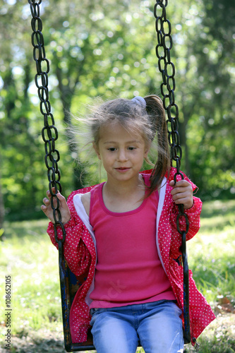 cute blonde girl swinging photo