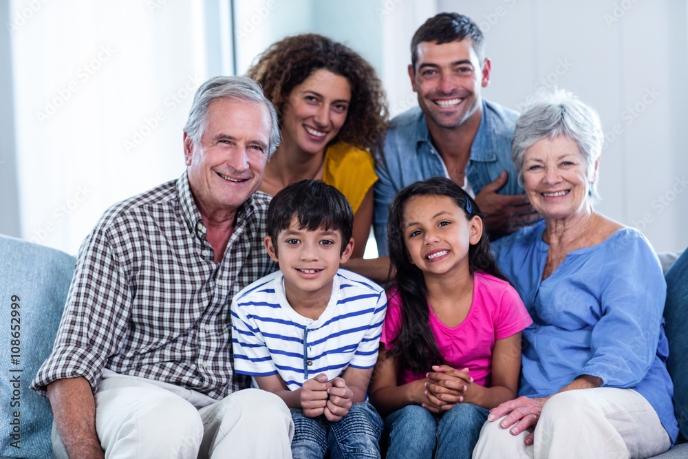 Portrait of happy family sitting together on sofa