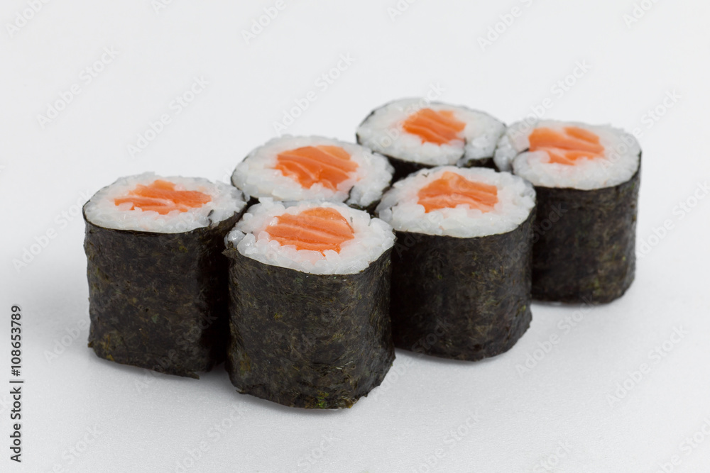 hosomaki with salmon, rice and nori on a white background hosomaki with salmon, rice and nori on a white background